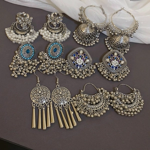 Detail of bohemian ethnic earrings featuring vintage silver plating and blue gemstones
