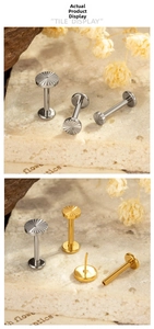 Detailed close-up of G23 titanium sunburst flat back labret studs in silver and gold
