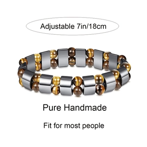 Macro detail of yellow tiger eye stone beads and hematite spacers on elastic bracelet