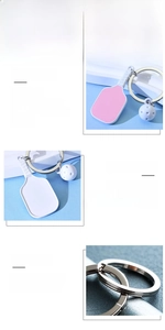 Detailed view of pink pickleball paddle keychain with a mini white ball charm