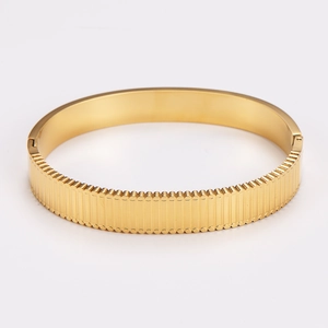 Polished gold 304 stainless steel bangle featuring a vertical column texture and clasp