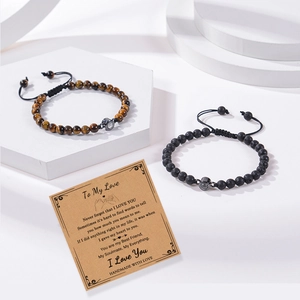 Close-up of tiger eye and lava stone couple bracelets with photo projection bead detail