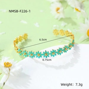 Detailed view of daisy open cuff bracelet in gold finish with green enamel petals