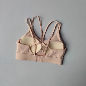 Detail of high-impact sports bra featuring multi-cross back straps and hook closure