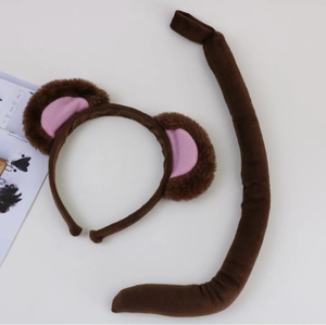 Detail of plush monkey ears headband and tail set in brown and pink for party costumes
