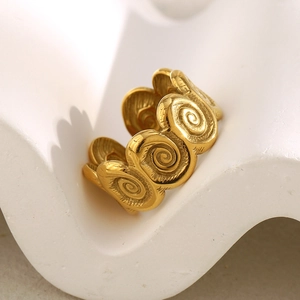 Detailed view of vintage gold seashell ring with 18K gold-plated spiral texture on white stand