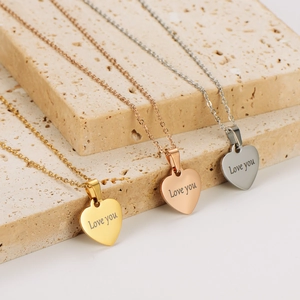 Three heart-shaped pendant necklaces in gold, rose gold, and silver with Love you engraving