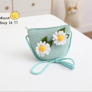 Detail of mint green woven crossbody bag for kids with white daisy floral decorations