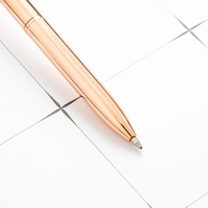 Elegant rose gold metal ballpoint pen with a sleek reflective surface for gift stationery