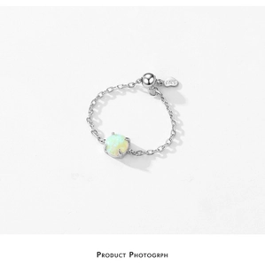 Detail of adjustable S925 silver chain ring with round opal and heart pendant