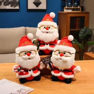 Trois peluches Père Noël de différentes tailles avec canne en sucre et panneau de joyeux Noël