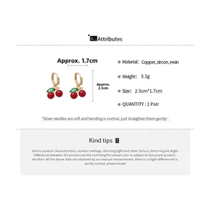 Detailed view of red cherry earrings with gold finish, zircon stones, and size dimensions