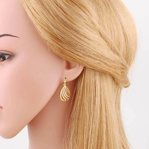 Elegant gold plated heart balloon earrings with cubic zirconia shown on female model