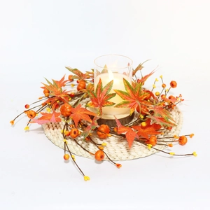 Macro detail of autumn candle ring with maple leaves, mini pumpkins and orange berries