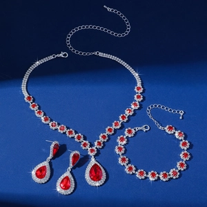 Detailed close-up of a silver jewelry set featuring vibrant red water-drop rhinestones