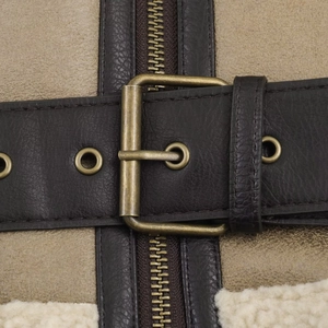 Macro detail of brown leather jacket with gold buckles and cream faux shearling lining