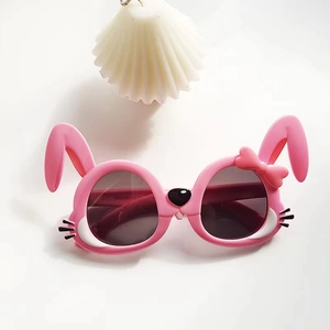 Close-up of pink bunny-shaped kids sunglasses with bow and rabbit ear details