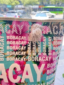 Close-up of burlap canvas bag with Boracay text print and tropical flower patterns