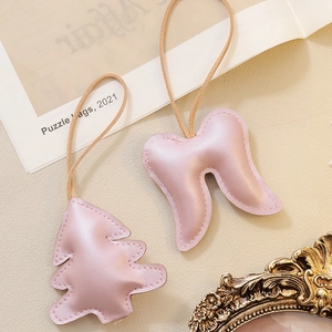 Pink pearlescent faux leather Christmas tree and wing ornaments with fine stitching