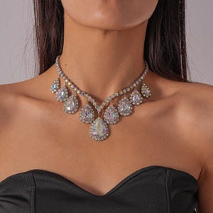 Macro shot of silver clavicle necklace featuring teardrop AB crystal pendant on a model