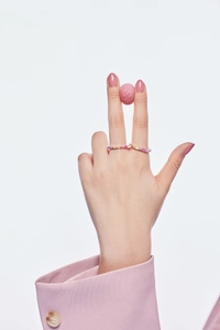 Close-up of S925 silver ring with gradient colored cubic zirconia on a female hand