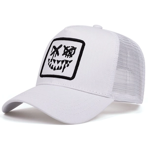 Detail of white trucker hat with black graffiti face embroidery and mesh back
