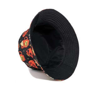 Detail view of Halloween double-sided bucket hat with colorful skull and pumpkin prints