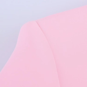 Detailed macro view of the stitching on pink blazer shoulder and feather cuff sleeve