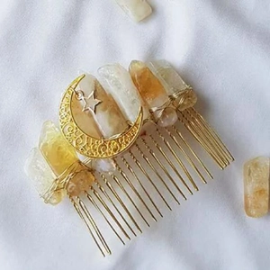 Macro detail of handmade bohemian hair comb with yellow crystals and golden moon charm