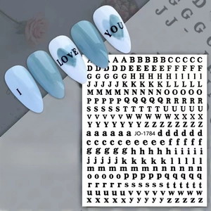 Detail of black alphabet nail art stickers with serif font for DIY manicure decoration