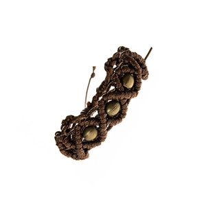 Close-up of handmade woven bracelet featuring three brass metal beads and brown cord