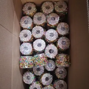 Bulk rolls of colorful Christmas bead chain decorations stored in cardboard boxes