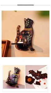 Detail of cat and bat themed wall shelves with mystical sun, moon, and star patterns