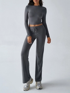 Detail of grey Y2K long sleeve top and drawstring pants set on a fashion model