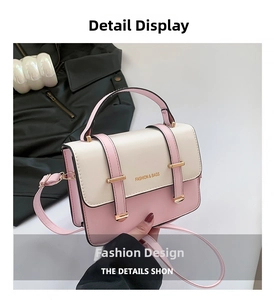 Close-up of contrast color small square bag with metal buckles and FASHION lettering