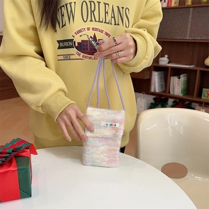 Detailed texture of rainbow knit plush phone bag with flap and purple woven strap
