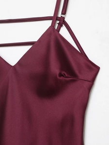 Detailed close-up of wine red satin midi dress featuring thin straps and silky texture