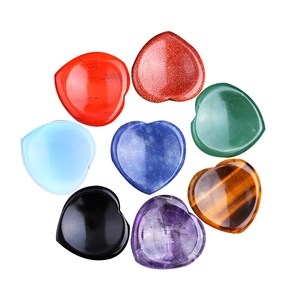 Set of 8 natural crystal heart thumb stones including amethyst and quartz on white background
