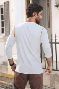 Rear view of a white long-sleeve polo shirt with orange contrast stitching and slim fit design