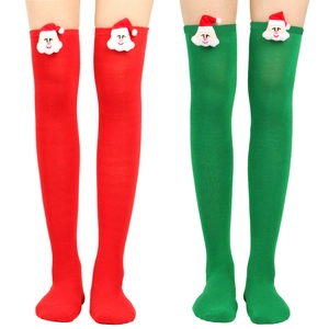 Detail of over-the-knee Christmas socks with 3D Santa Claus plush toys in red and green