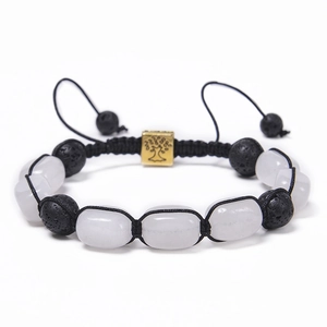 Detail of hand-woven bracelet with lava stones, white beads, and gold Tree of Life charm
