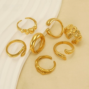 Detailed view of a 7-piece set of 18K gold plated minimalist rings in various textures