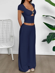 Navy blue knit two-piece set featuring a V-neck cutout top and wide-leg trousers