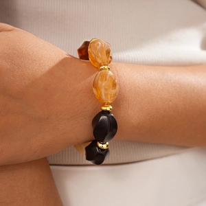 Detailed shot of amber and black acrylic faceted beads on a vintage beaded necklace