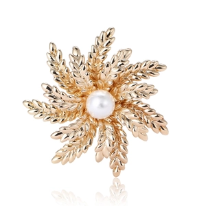 Elegant gold alloy wheat ear brooch with white pearl on a clean white background