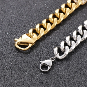 Detailed close-up of gold and silver cuban link bracelets with sparkling rhinestone accents