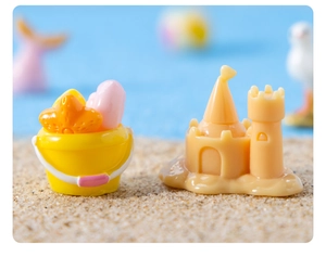 Macro view of miniature beach sand bucket and castle toys for micro landscape DIY decor