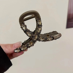 Detail of champagne brown rhinestone hair claw clip with Love Days engraving on metal