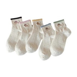 Five pairs of cute dog embroidered cotton crew socks in cream color with speckled yarn