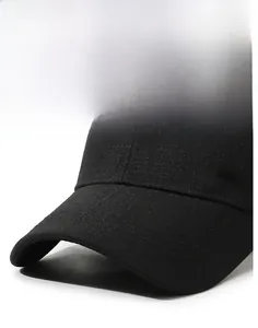 Detail of black baseball cap showing the golden metal logo and reinforced stitching